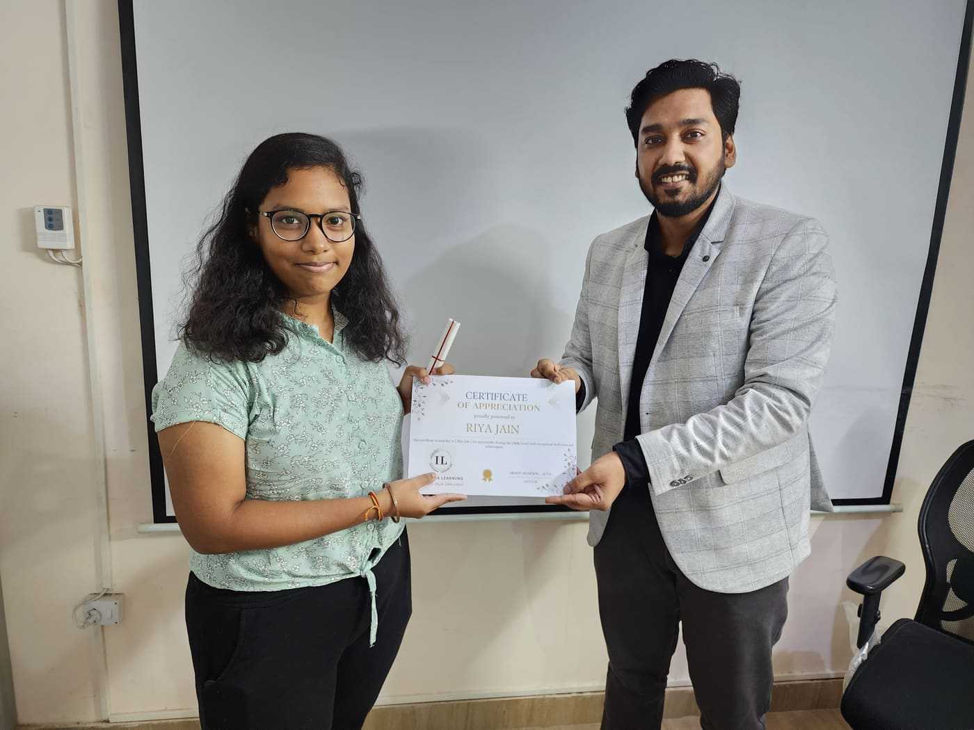 Riya Jain receiving ACCA certificate from Mohit Agarwal at Ikshana Learning