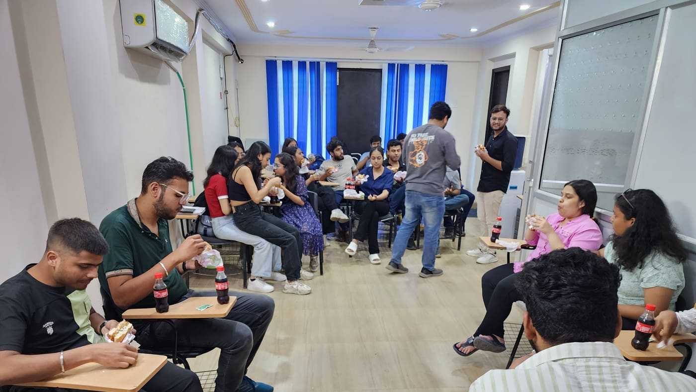 Students celebrating with snacks after ACCA certificate ceremony
