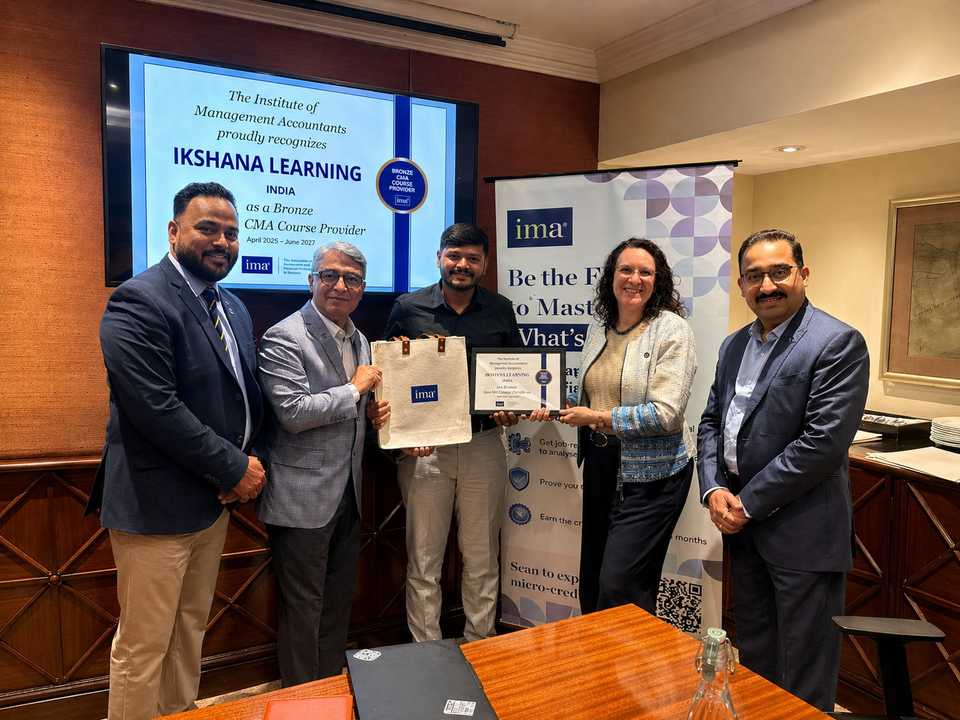 Ikshana Learning team receiving the IMA Bronze CMA Course Provider plaque from the Institute of Management Accountants